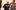 Image 3 people, smiling. They both have their hands to their chest, and appear to be speaking.