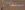 A cork board with a magnifying glasss. The text is cut out cereal box letters that read, 