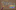 A cork board with a magnifying glasss. The text is cut out cereal box letters that read, 