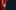 A hand pulling back a red velvet curtain with a black background.